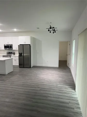 a utility room with wooden floor washer and dryer