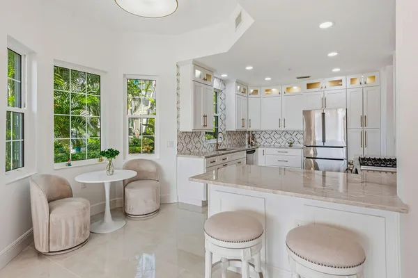 a kitchen with a white stove top oven and couches