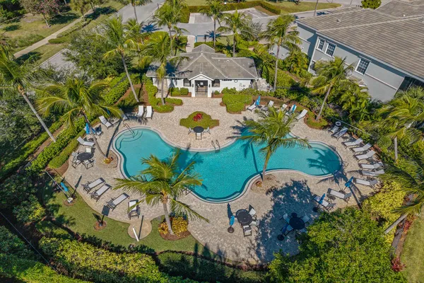 an aerial view of a house with a yard and garden