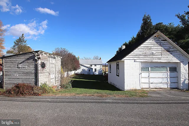 a view of a white house with a street