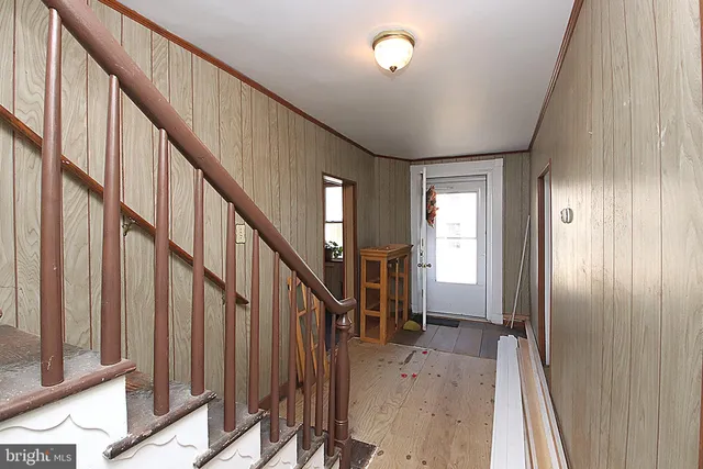 a view of entryway with wooden floor and stairs