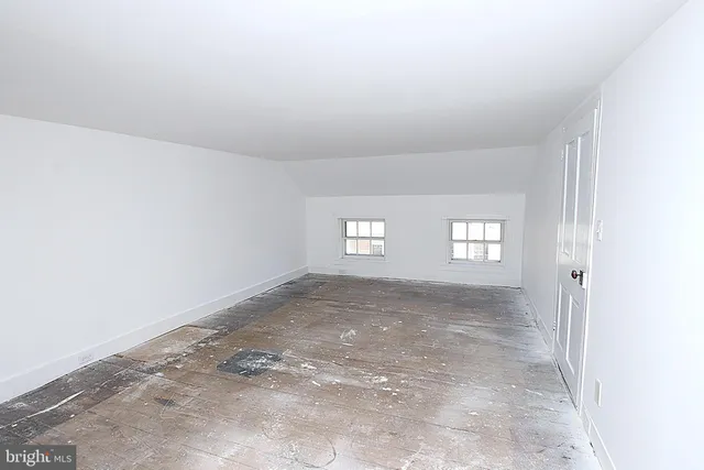 a view of a big room with window and closet area