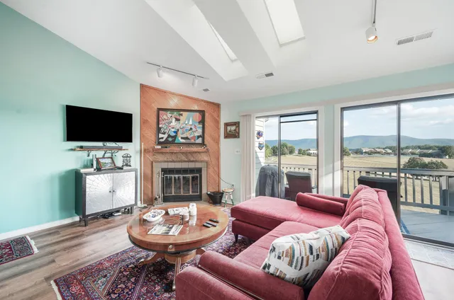a living room with furniture a fireplace and a flat screen tv
