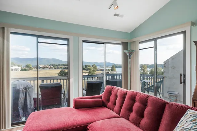 a bedroom with furniture and a large window