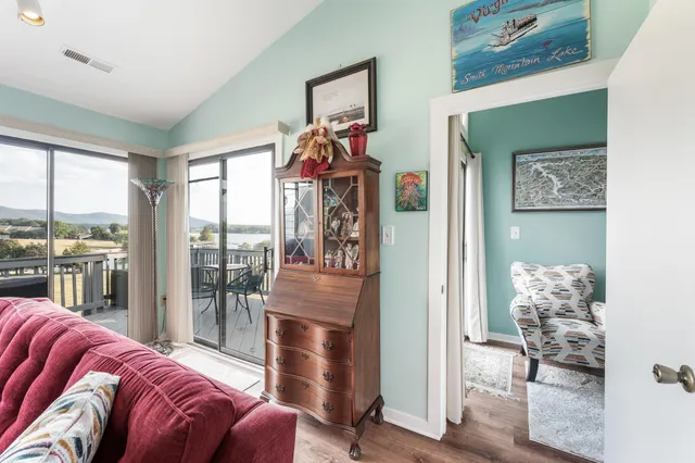 a living room with furniture and a floor to ceiling window
