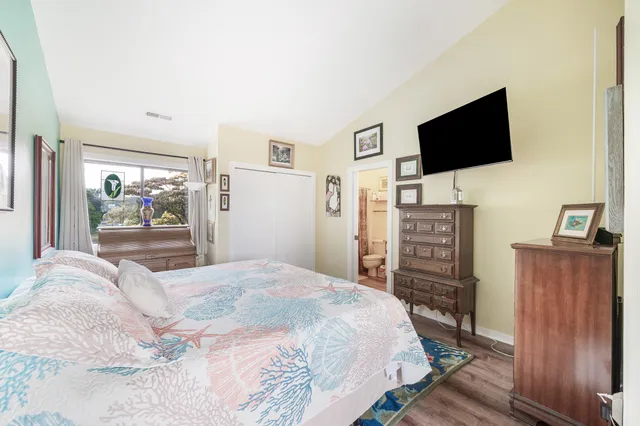 a bedroom with a bed and a flat screen tv