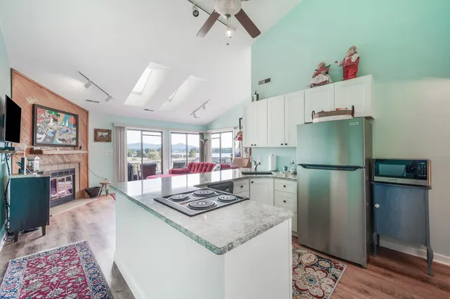 a kitchen with stainless steel appliances granite countertop a refrigerator and a stove top oven