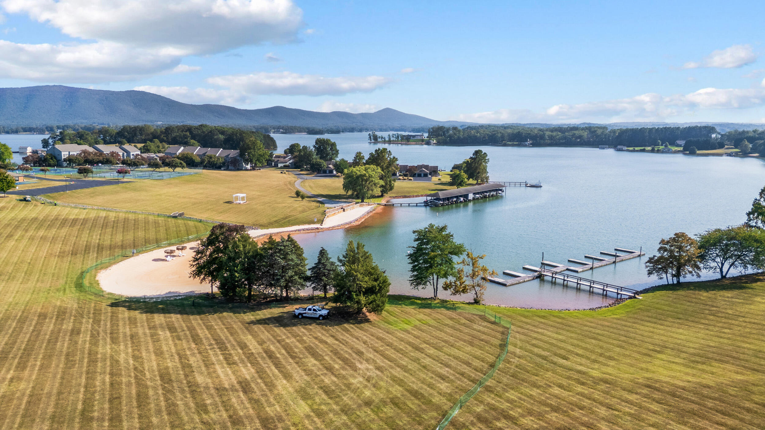 150 Sailor's Cove Drive, Unit 1218 Moneta, VA 24121 - Photo 35 of 56 a view of a lake with a mountain in the background