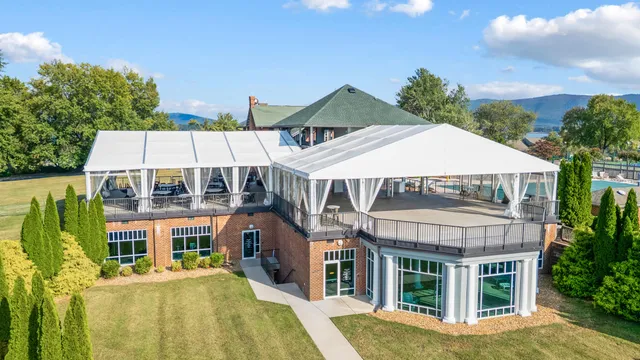 a view of a patio with table and chairs under an umbrella