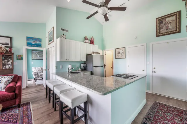 a kitchen with a table chairs refrigerator and microwave