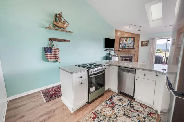 a kitchen with stainless steel appliances granite countertop a stove and a sink