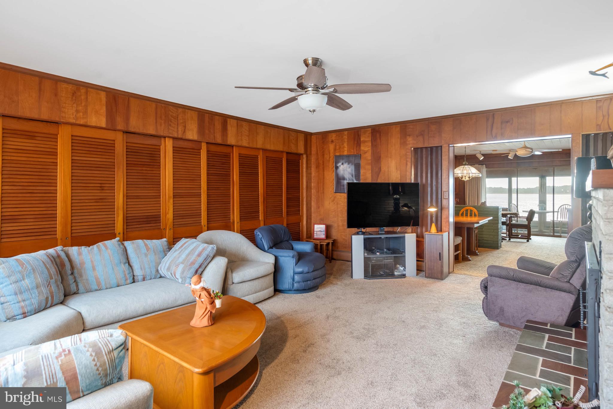 31266 River Road Millsboro, DE 19966 - Photo 11 of 47 a living room with furniture ceiling fan and a flat screen tv