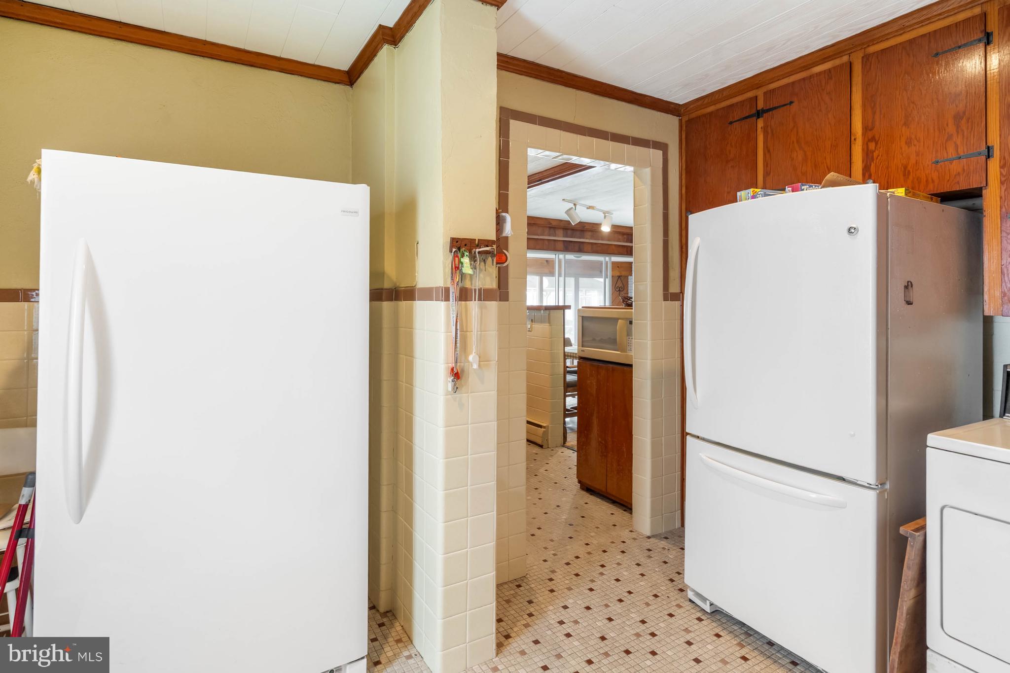 31266 River Road Millsboro, DE 19966 - Photo 17 of 47 a white refrigerator freezer and a stove sitting inside of a kitchen