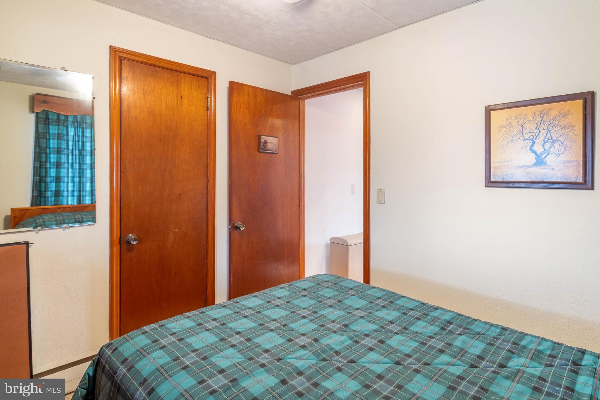 31266 River Road Millsboro, DE 19966 - Photo 29 of 47 a bedroom with a bed and wooden floor