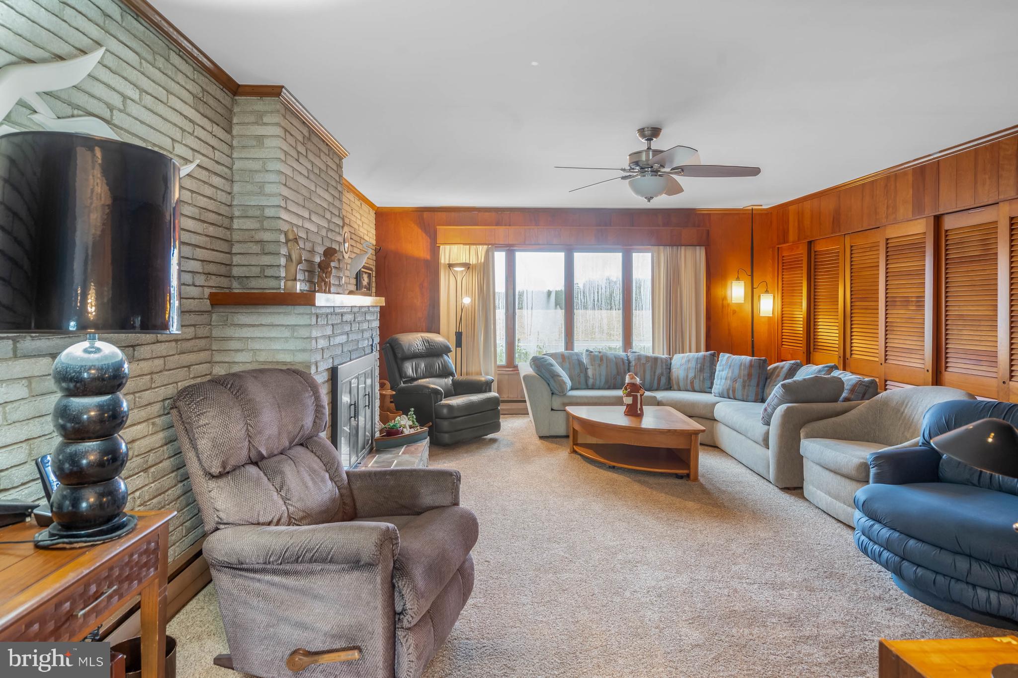 31266 River Road Millsboro, DE 19966 - Photo 6 of 47 a living room with furniture a fireplace and a flat screen tv