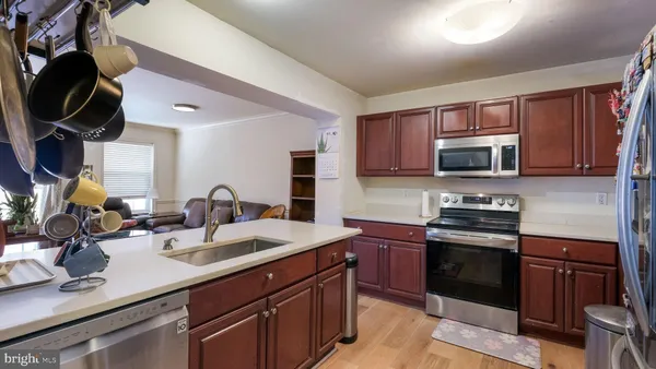 a kitchen with sink a microwave and cabinets