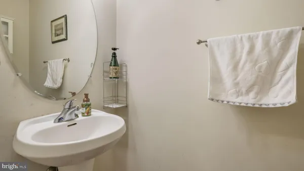 a bathroom with a sink a mirror and vanity