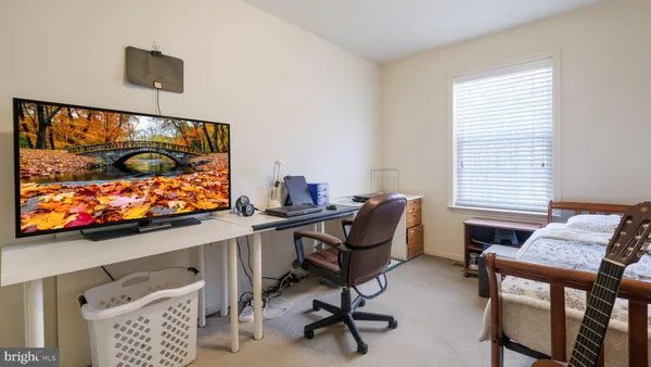 a view of a workspace with furniture and a flat screen tv