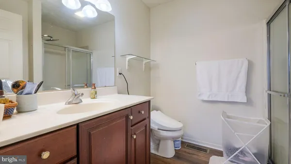 a bathroom with a sink toilet and mirror