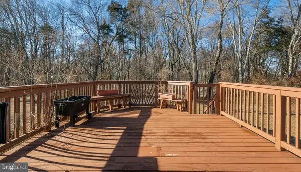 a balcony with wooden floor and outdoor space