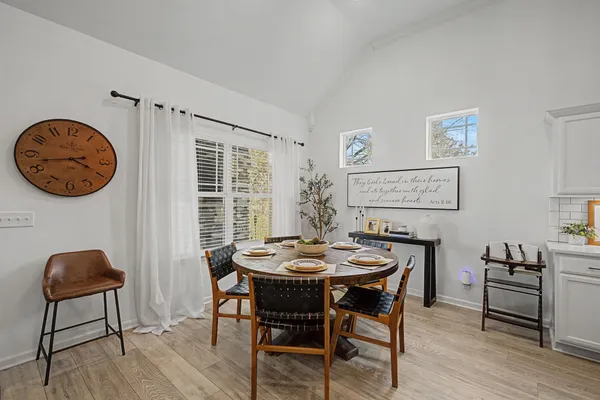 a dining room with furniture and wooden floor