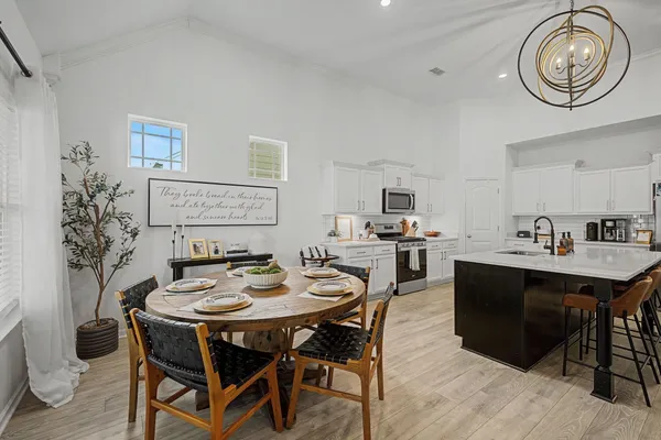 a view of a dining room with furniture and wooden floor