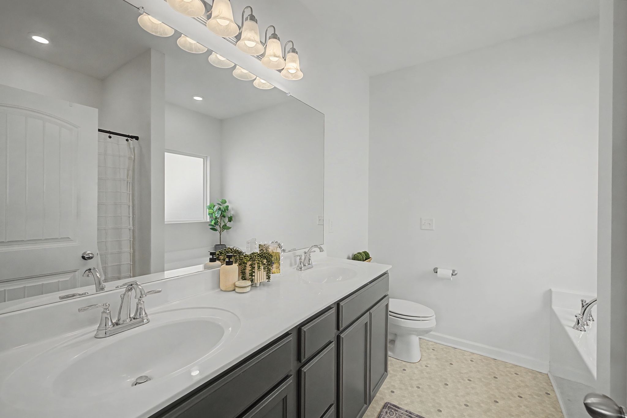 5310 Pointer Place Murfreesboro, TN 37129 - Photo 16 of 40 a bathroom with a sink a toilet and a mirror