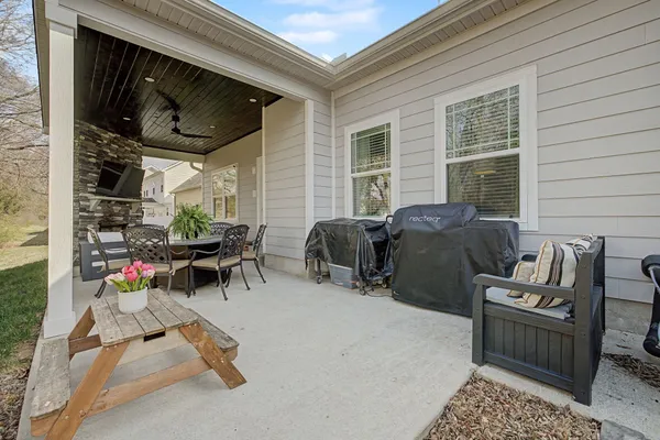 a building outdoor space with patio furniture and potted plants