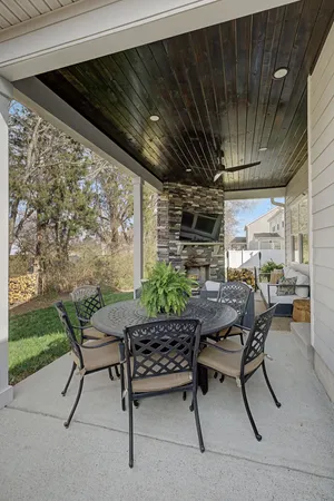 a view of a backyard with table and chairs with wooden floor and fence