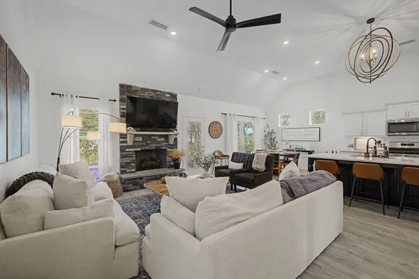 a living room with furniture a clock and a flat screen tv
