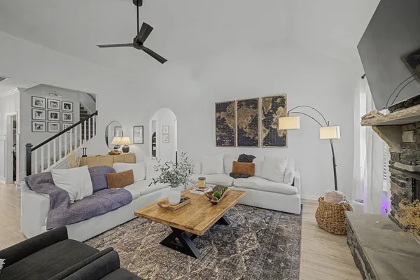 a living room with furniture and wooden floor