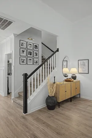 a living room with furniture and wooden floor