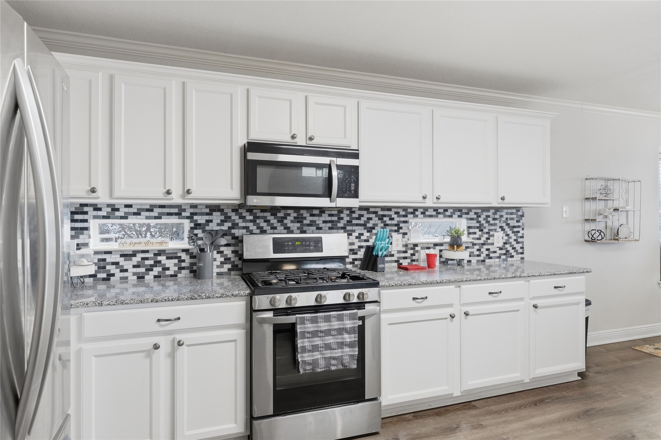 258 Hogan Kyle, TX 78640 - Photo 12 of 40 a kitchen with white cabinets and appliances