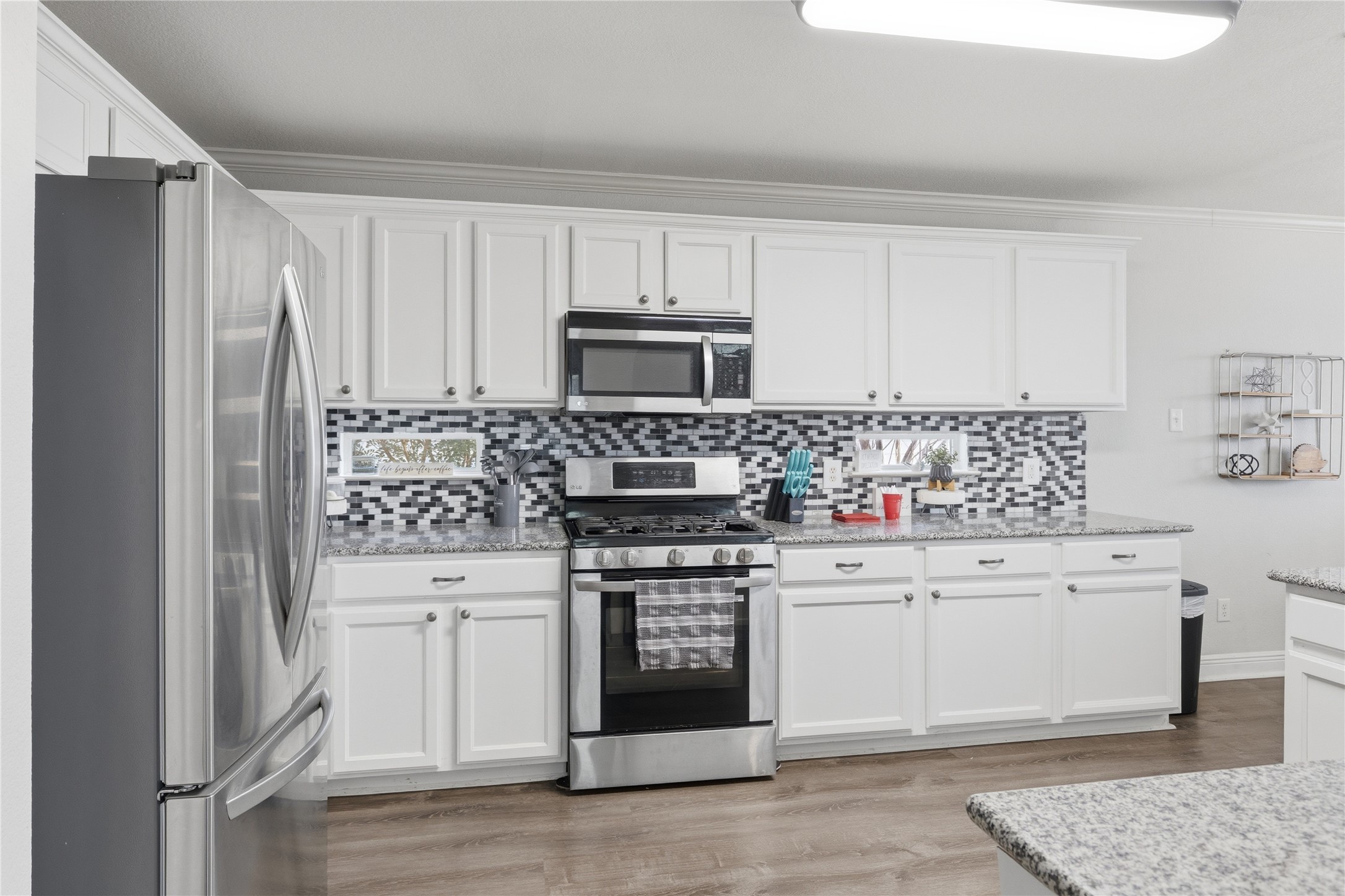 258 Hogan Kyle, TX 78640 - Photo 14 of 40 a kitchen with stainless steel appliances a stove a sink and a refrigerator