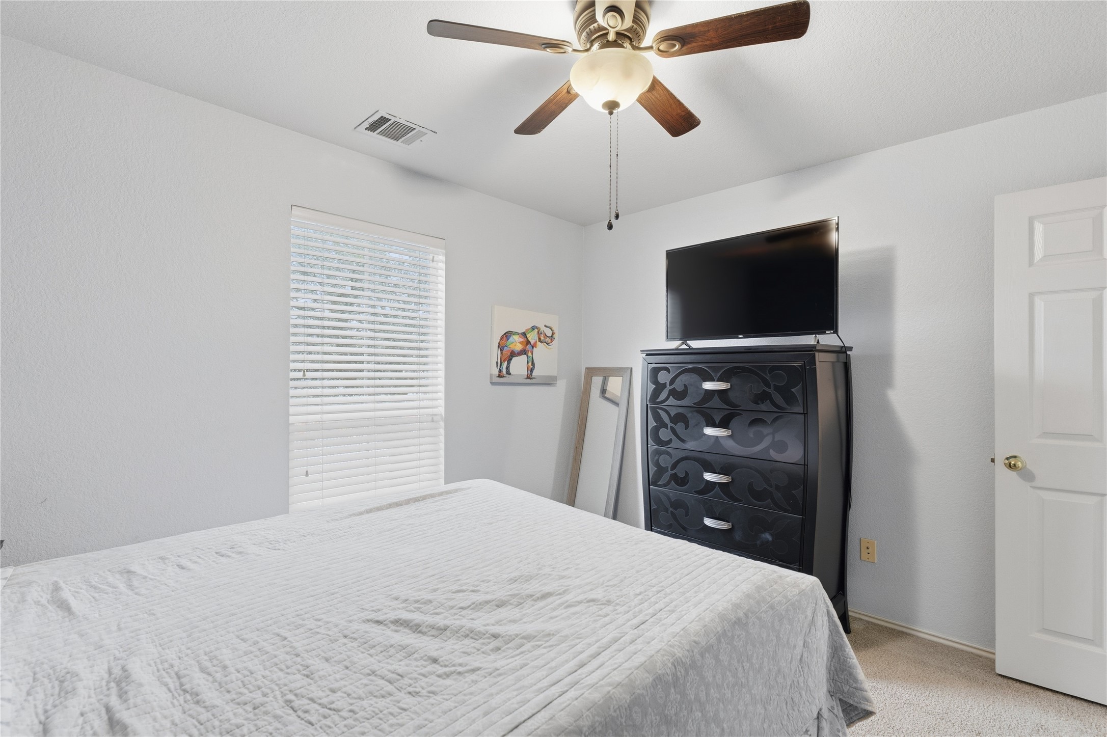 258 Hogan Kyle, TX 78640 - Photo 23 of 40 a bedroom with a bed and a flat screen tv