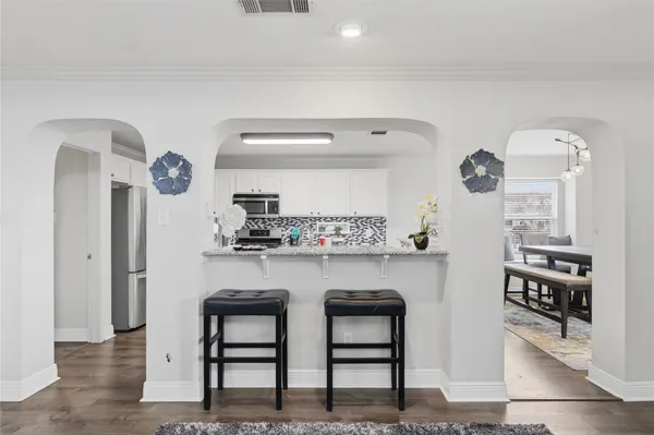 a kitchen with stainless steel appliances granite countertop a sink and cabinets