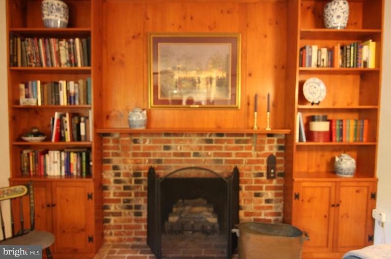 9224 Rockefeller Lane Springfield, VA 22153 - Photo 9 of 25 Gas fireplace and built-in shelves and cabinets