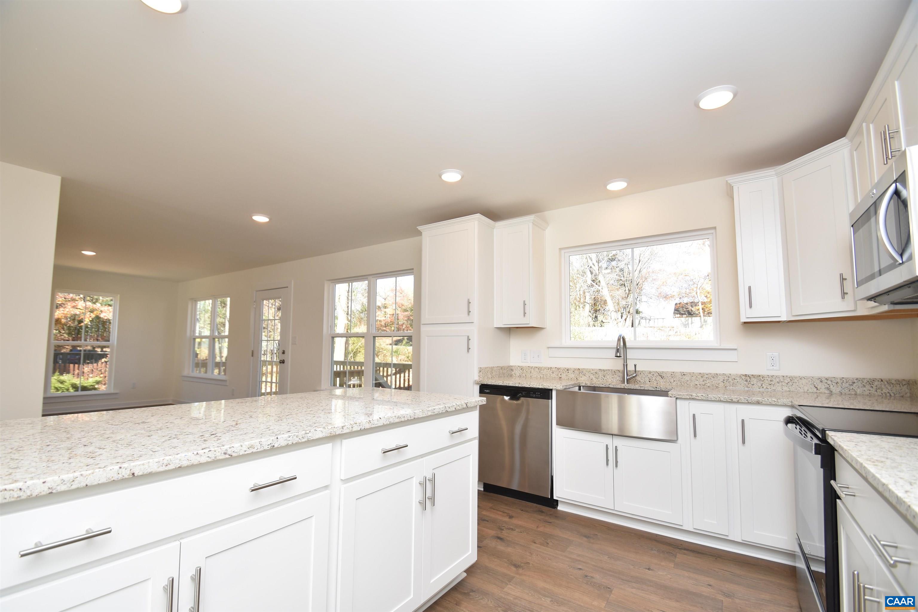Lot4 Kidds Dairy Road, Unit KD4 Scottsville, VA 24590 - Photo 8 of 26 a kitchen with stainless steel appliances granite countertop a sink and cabinets with wooden floor