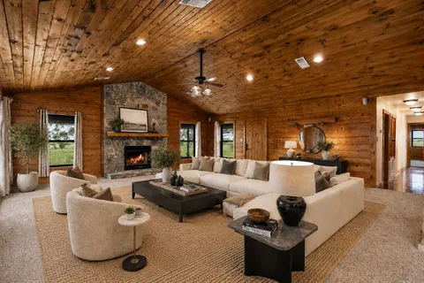 a living room with furniture and a fireplace