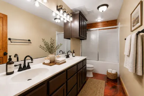 a bathroom with a double vanity sink and a mirror