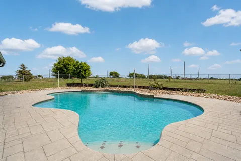 a view of a swimming pool and an outdoor space