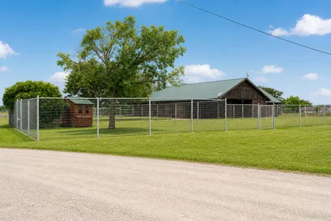 a view of a house and a yard and a street view