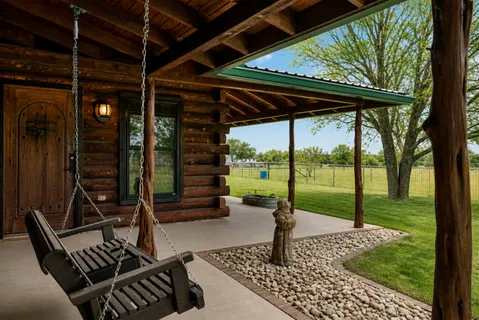 a view of a porch with furniture and yard