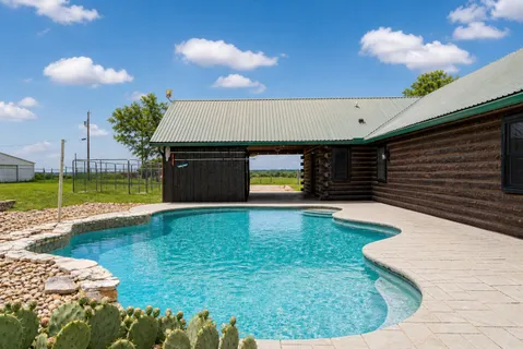 a view of a swimming pool with a yard