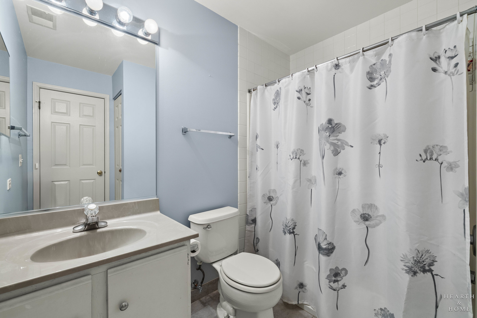 330 Buckingham Circle, Unit C Elgin, IL 60120 - Photo 12 of 21 a bathroom with a granite countertop sink toilet a mirror a vanity and shower