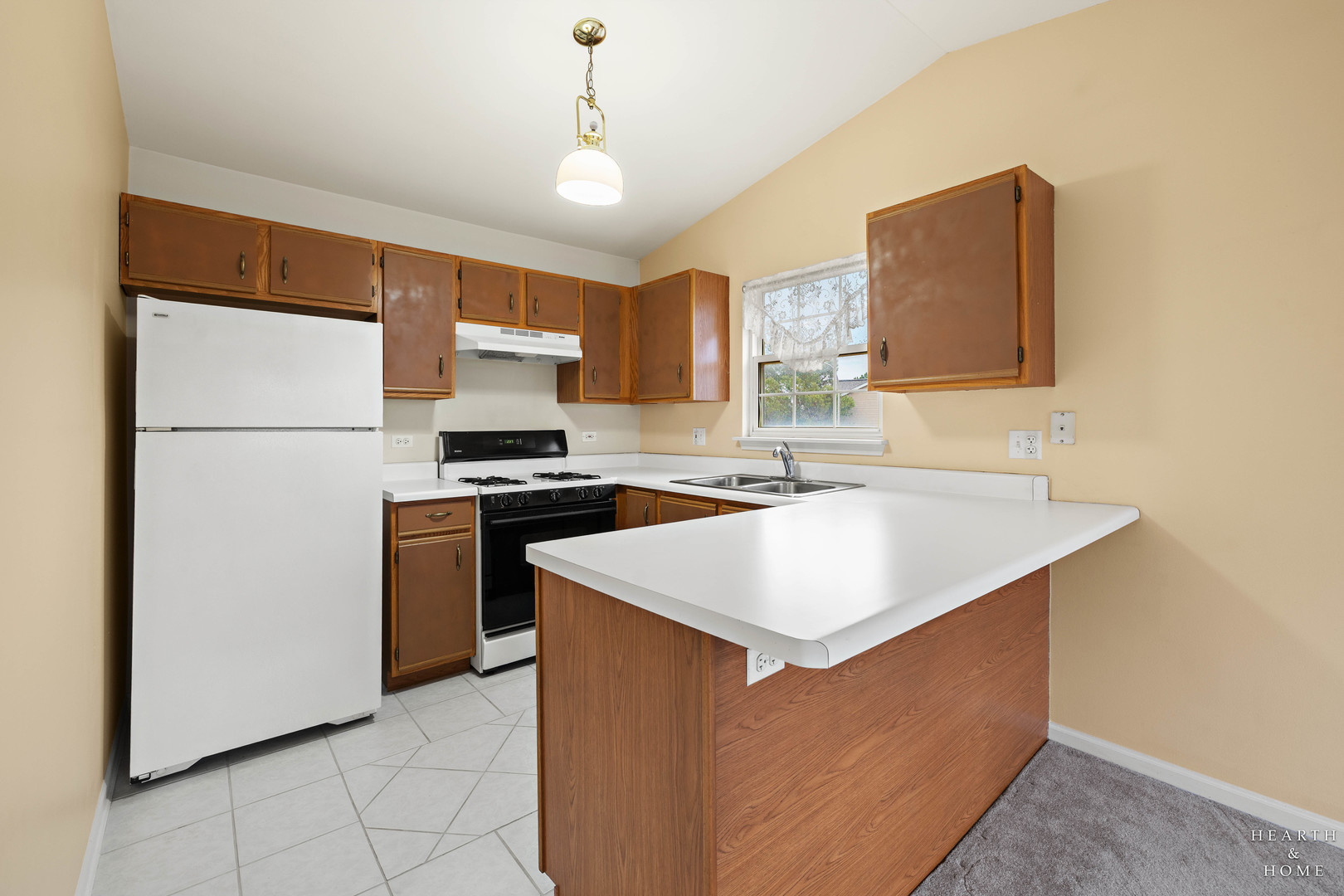 330 Buckingham Circle, Unit C Elgin, IL 60120 - Photo 16 of 21 a kitchen with a sink a stove and a refrigerator