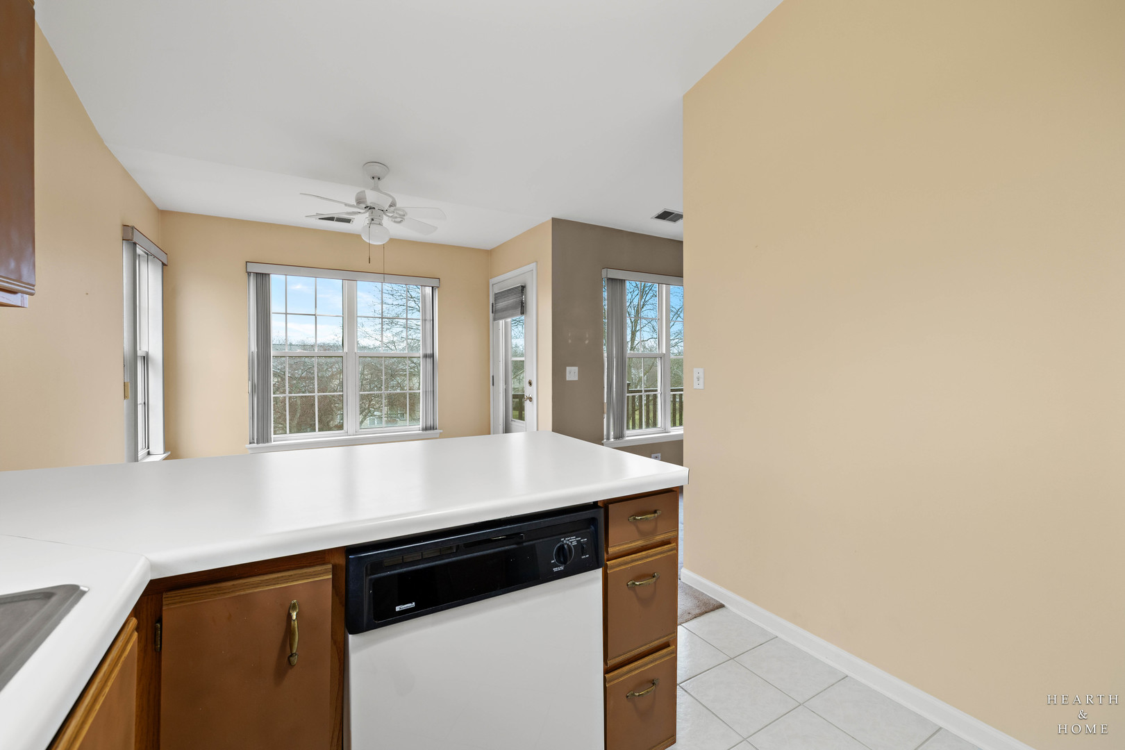 330 Buckingham Circle, Unit C Elgin, IL 60120 - Photo 17 of 21 a view of a kitchen with granite countertop cabinets stainless steel appliances and a window