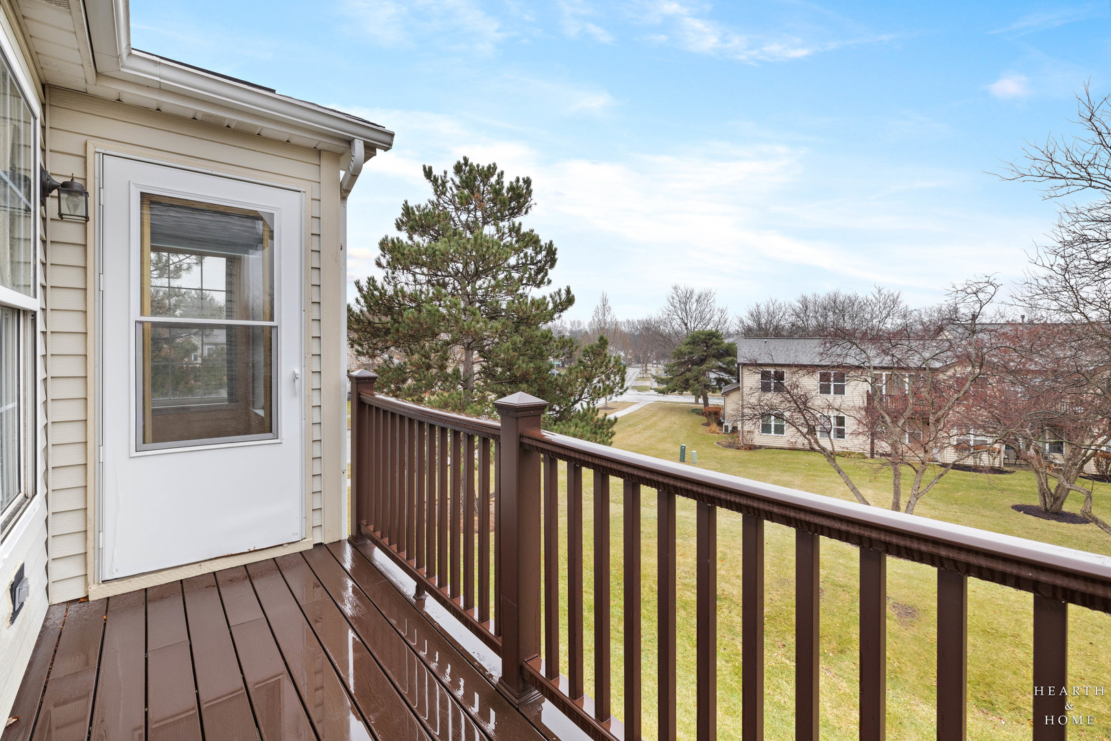330 Buckingham Circle, Unit C Elgin, IL 60120 - Photo 4 of 21 a view of a balcony with wooden floor and fence