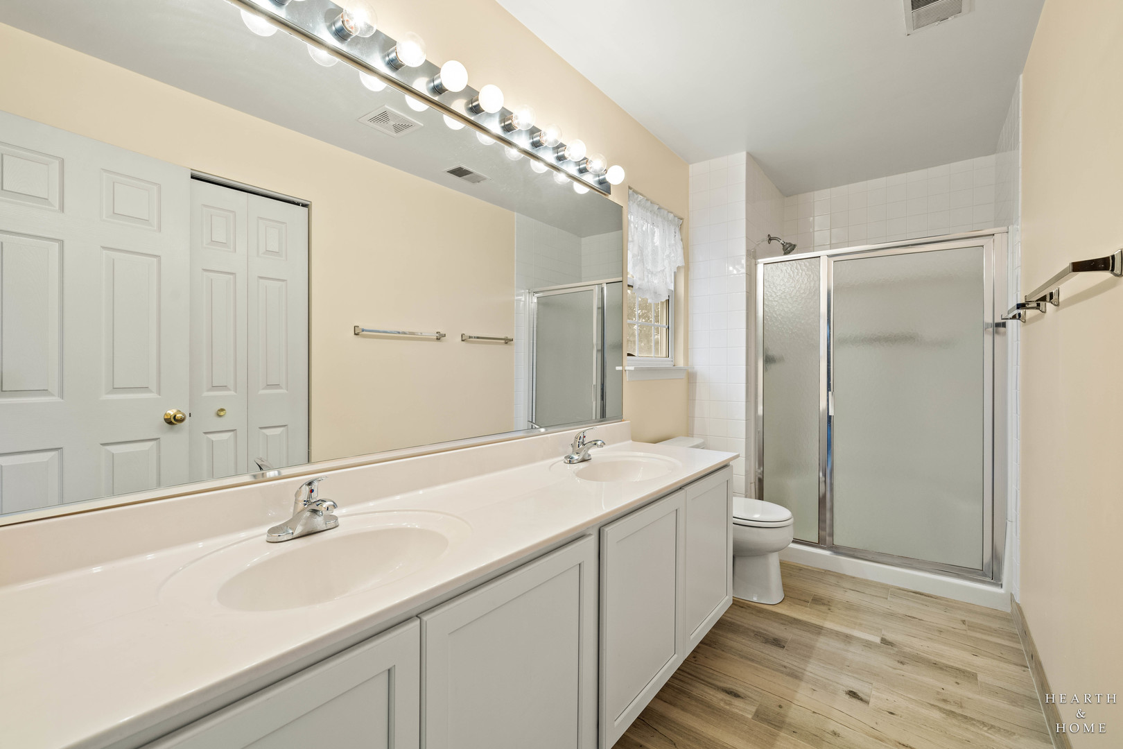 330 Buckingham Circle, Unit C Elgin, IL 60120 - Photo 10 of 21 a bathroom with a double vanity sink mirror and toilet
