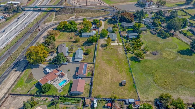 an aerial view of residential house with outdoor space and swimming pool